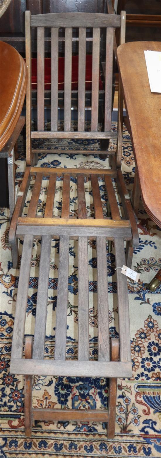 A pair of teak lounger chairs